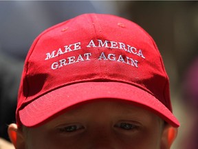 A young Donald Trump supporter sports a pro-Trump hat during rally in front of Cobo Hall in Detroit on Aug. 8, 2016.