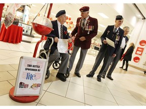 Raymond Pease, left, Bob Kelly, Bill Vivian and Frank Doolittle stand next to a donation kettle as veterans helped the Salvation Army with their annual kettle campaign at Devonshire Mall in Windsor in December 2014.