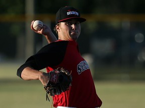 Windsor Junior Selects Matthew Krutsch throws against the Tecumseh Thunder Seniors at Lacasse Park in Tecumseh on June 8, 2016.