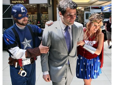 May 17, 2013: Capt. Crime Stoppers, left, and Lady Justice arrest Fred Francis, centre, of Rafih Auto Group during the annual Bail or Jail fundraiser for Windsor and Essex County Crime Stoppers at Devonshire Mall.