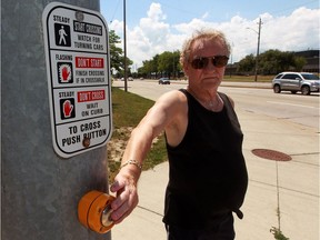 Pedestrian Bob Cecile wants more time to cross seven lanes of road at Lauzon Parkway at Hawthorne Street, seen here on Aug. 2, 2016.