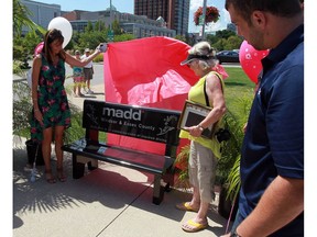 Jennifer Musson, left, and Margaret Collins unveil a Mothers Against Drunk Driving memorial bench in Dieppe Park Wednesday, Aug. 3, 2016.