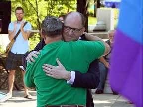 Windsor Mayor Drew Dilkens embraces Joe McParland after Dilkens addressed a large crowd at Pride Week flag-raising ceremony at Windsor City Hall on Wednesday, Aug. 3, 2016.