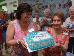 Bibles for Missions Thrift Store manager Sharlene Rehman, left, presents longtime volunteer Vida Creamer with a birthday cake to celebrate her 90th birthday on Aug. 4, 2016.