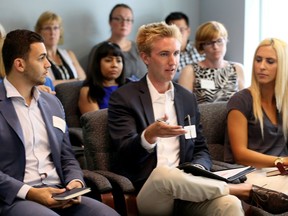 Chase Stoyshin, centre, of Essex Linen Supplies, asks about rising utility costs during Windsor-Essex Regional Chamber of Commerce small business round table with Ontario Chamber of Commerce president Allan O'Dette Aug. 9, 2016. Peter Corio, left, and Yvonne Pilon, right, listen.