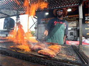 Mark Scarlett from Toronto's Brick Yard BBQ grills ribs during the Windsor Ribfest at the Riverfront Festival Plaza on Aug. 11, 2016.