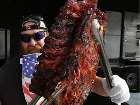 Tex Robert Jr. from Louisiana Bar-B-Que displays his prize-winning ribs during the Windsor Ribfest 2016.