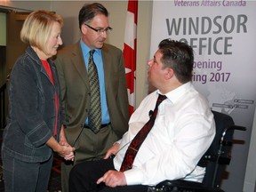 Theresa Charbonneau, left, mother of Cpl. Andrew Grenon who was killed while serving with Canadian Army in Afghanistan, and Windsor-West MP Brian Masse speak with Minister of Veterans Affairs Kent Hehr, right, at media conference announcing the reopening of a local office of Veterans Affairs Canada on Aug. 12, 2016.
