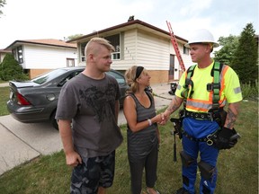 Dallin Grantmyre, left, with step mother Mary Ann Gough, thank owner of All Star Roofing  Nigel Poag as his crews repair a leak at Gough's home on Aug. 17, 2016.