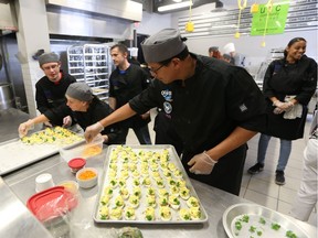 Students prepare food in the newly named Caesars Windsor Cares Community Kitchen at the Unemployed Help Centre of Windsor Inc. on Aug. 18, 2016.