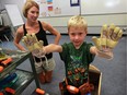 Senior kindergarten student Camden McFarlane explores toy tools in Grade 1/kindergarten class at Our Lady of Mount Carmel School on Aug. 29, 2016. Camden's mother, teacher Cheryl McFarlane, left, works at the South Windsor school.