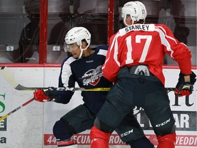 Jeremiah Addison, left, takes a hit from Logan Stanley during three-on-three drills at the WFCU Centre on Aug. 30, 2016.