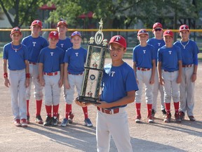 Joel Tortorici of the Tecumseh Rangers holds the Golden Arm award while being surrounded by his teammates on Aug. 4, 2016. Tortorici won the trophy in Cooperstown, N.Y.