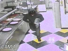 A suspect wanted in connection with a robbery at a Little Caesars on Aug. 6 is pictured in this surveillance photo.