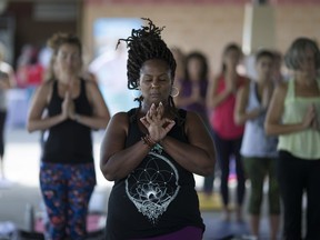 Women participate in a class at Yoga for Hope at the Vollmer Culture and Recreation Complex, Saturday, August 27, 2016.