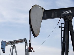 Oil pump jacks are seen in a field near Leduc, Alta., on March 4, 2016.