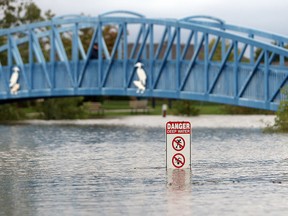 A warning sign is seen at Blue Heron Park during flooding in east Windsor on September 29, 2016.