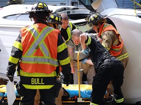 An elderly male driver of an SUV needed to be removed through the front windshield frame of his vehicle after being involved in a collision Thursday, Sept. 22, 2016, on Matchette Rd. in Windsor, ON. The accident occurred shortly after 1 p.m. and shut down Matchette west of Prince for almost an hour. Emergency personnel help the man out of his vehicle. (DAN JANISSE/The Windsor Star)