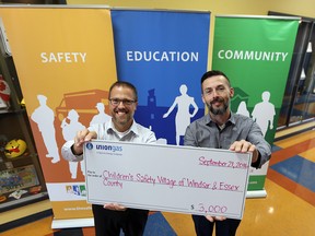 Sean Collier, Union Gas District Manager Windsor/Chatham, presents a cheque for $3,000 to Michael Lucier, The Safety Village Executive Director on September 21, 2016. (JASON KRYK/Windsor Star)
