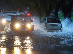 Vehicles pass through a section of Jefferson Blvd. that was flooded on Thursday, September 29, 2016, in Windsor, ON. Heavy rains caused flooding in much of the area. (DAN JANISSE/The Windsor Star)