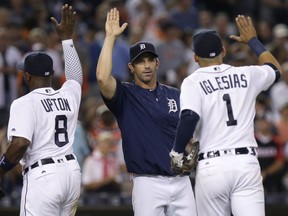 Manager Brad Ausmus of the Detroit Tigers celebrates with Justin Upton (8) and Jose Iglesias (1) after a 4-3 win over the Baltimore Orioles at Comerica Park on Sept. 9, 2016 in Detroit, Mich.