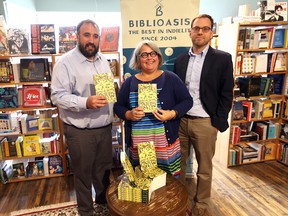 Rino Bortolin, City of Windsor councillor, left; Cathy Masterson, the city's manager of cultural affairs, and Grant Munroe, director of marketing and publicity for Biblioasis, hold copies of Catherine Leroux's The Party Wall, which has been shortlisted for the $100,000 Giller prize.