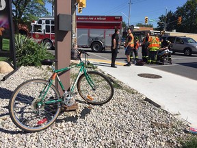 Emergency responders help a cyclist who was struck by a vehicle at Tecumseh Road East and Westminster Boulevard on the afternoon of Sept. 19, 2016. Injuries were minor.