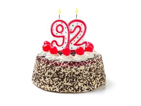 Birthday cake with burning candle number 92. Image by Getty Images.