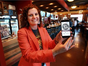 Lynette Bain, vice-president of tourism programs and development for Tourism Windsor Essex Pelee Island, displays a new Barrels, Bottles and Brews trail app launched at the Frank Brewing Co. in Tecumseh on Sept. 7, 2016.