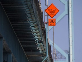 Construction signs warning of lane reductions can be seen on the Ambassador Bridge on Sunday, Sept. 4, 2016.  Concrete barriers have been put in place between traffic and the curb due to an emergency directive from Transport Canada after the agency found safety deficiencies on the Canadian side of the  bridge.