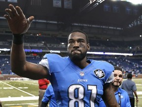 In this Nov. 9, 2014, file photo, Detroit Lions wide receiver Calvin Johnson waves to fans after defeating the Miami Dolphins 20-16 in a NFL football game in Detroit.