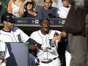 Detroit Tigers right fielder J.D. Martinez, left, and manager Brad Ausmus hold back Cameron Maybin, centre, after Maybin was ejected by home plate umpire Dan Iassogna against the Kansas City Royals on Sept. 25, 2016 in Detroit.