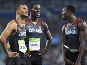 Canada's Andre De Grasse, left to right, Brendon Rodney and Aaron Brown watch the scoreboard following the men's 4x100-metre relay final at the 2016 Summer Olympics in Rio de Janeiro, Brazil on Aug. 19, 2016. Canada won the bronze medal.