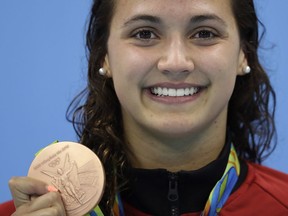Canada's Kylie Masse, of LaSalle, shows off her bronze medal during the ceremony for the women's 100-metre backstroke final during the swimming competitions at the 2016 Summer Olympics, Monday, Aug. 8, 2016, in Rio de Janeiro, Brazil.