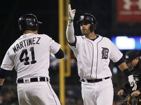 J.D. Martinez (28) of the Detroit Tigers celebrates with Victor Martinez (41) after hitting a two-run home run against the Cleveland Indians during the second inning at Comerica Park on September 26, 2016 in Detroit, Mich.