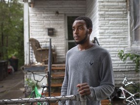 Denzel Dodd, 22, a lifelong resident of the southwest neighbourhood of Delray, stands outside his home on Saturday, Sept. 17, 2016, that has been in his family for three generations. Dodd's home is on the land where the future U.S. customs plaza is to be built.