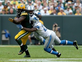 Glover Quin #27 of the Detroit Lions tackles Eddie Lacy #27 of the Green Bay Packers in the fourth quarter at Lambeau Field on September 25, 2016 in Green Bay, Wisconsin.