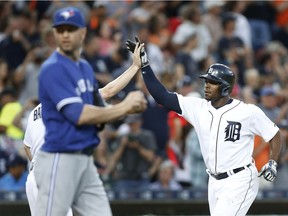 Detroit Tigers' Justin Upton, right, celebrates his two-run home run as Toronto Blue Jays pitcher J.A. Happ walks back to the mound in the third inning of a baseball game, Monday, June 6, 2016 in Detroit. The Jays and Tigers may meet in this year's MLB playoffs.