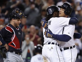 Detroit Tigers' Miguel Cabrera, right, celebrates his three-run home run with Cameron Maybin in front of Cleveland Indians catcher Adam Moore during the second inning of a game in Detroit on Sept. 27, 2016.