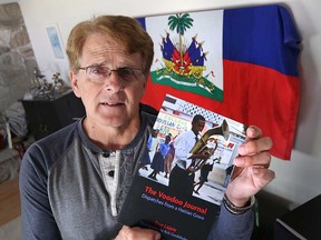 Former Windsor Star reporter Don Lajoie is pictured at his home with a copy of The Voodoo Journal - the book he authored with photos by Rob Gurdebeke.