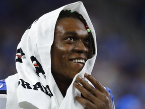 Detroit Lions defensive end Ezekiel Ansah watches from the bench in the second half of an NFL preseason football game against the Cincinnati Bengals in Detroit on Aug. 18, 2016.