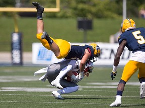 University of Windsor Lancers linebacker Daniel Metcalfe, seen making a tackle  against Guelph's Ryan Nieuwesteeg, was named an OUA football all-star on Wednesday.