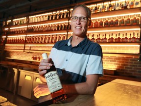 Hiram Walker and Sons distillery's master blender Don Livermore is shown with a bottle of JP Wiser Whisky, the company's flagship product on Tuesday, Sept. 14, 2016.