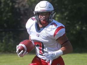 Zach Herzog runs for one of three touchdowns for Holy Names in a 41-0 victory over St. Anne Friday, Sept. 16, 2016, at the Windsor Stadium.