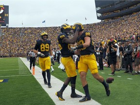 Michigan tight end Jake Butt (88) celebrates his touchdown with wide receiver Jehu Chesson, center, in the second quarter against Central Florida at Michigan Stadium in Ann Arbor, Mich., Saturday, Sept. 10, 2016.