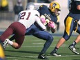 Windsor running back, Tarrence Crawford, is taken down by Ottawa's Ty Cranston during the OUA football quarterfinal between the Windsor Lancers and the Ottawa Gee Gees at Alumni Field, Saturday, Nov.1, 2014.  Windsor lost to Ottawa 46-29.