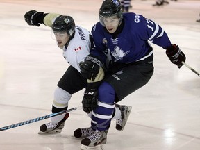 LaSalle' Brett Primeau, left, holds off London's Quinn Lenihan in Jr. B hockey action at Vollmer Centre September 14, 2016.