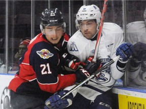 Windsor's Logan Brown, left, checks Mississauga's  Stephen Gibson during OHL action at the Hershey Centre in Mississauga on Friday, Oct. 30, 2016.