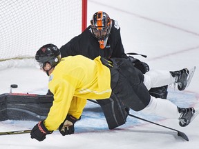 Team North America player Dylan Larkin collides with goaltender Matt Murray during training camp in Montreal on Monday, Sept. 5, 2016, ahead of the 2016 World Cup of Hockey competition.