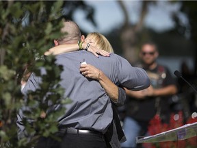 Theresa Charbonneau, mother of the late Cpl. Andrew Grenon, who was killed in Afghanistan, hugs Mark Oleynik, an Afghanistan veteran who was deployed with Grenon, at the Afghanistan and Peacekeepers Memorial on the 15th anniversary of the 9-11 terrorist attack, Sunday, Sept. 11, 2016.